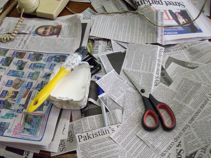 Scissors and glue being used in the archive at a newspaper in Bulawayo, Zimbabwe in 2010 photograph by David Brewer