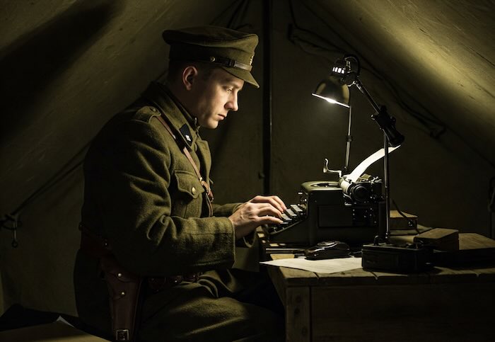 Journalist writing at a typewriter in army fatigues. Image created with Gemini AI