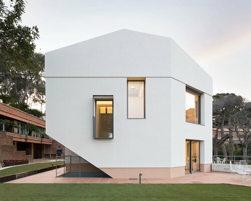 sculptural residence in spain emerges as an all-white monolith among tall pines